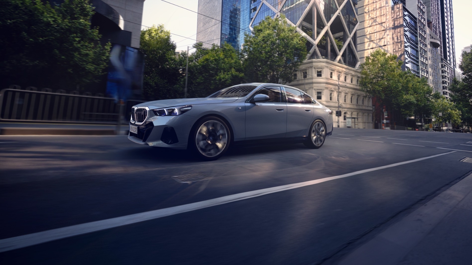The new BMW i5 Exterior driving in the city