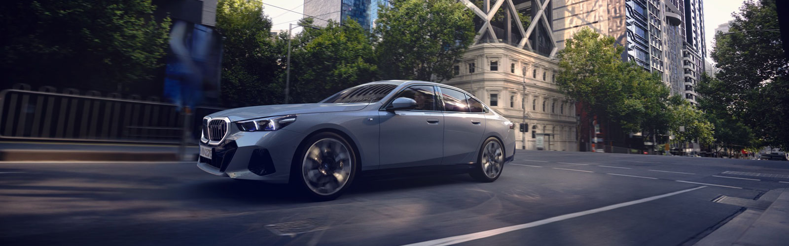 BMW i5 driving through a city