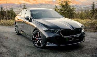 BMW i5 atop a mountain