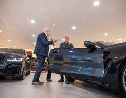 Customers looking at a BMW in the showroom