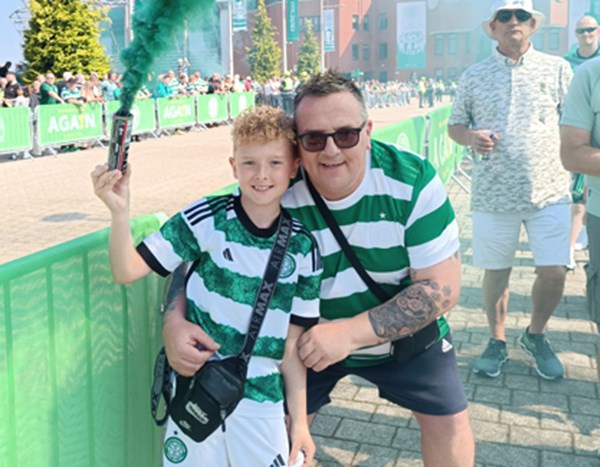 Lyle and his son at a football match