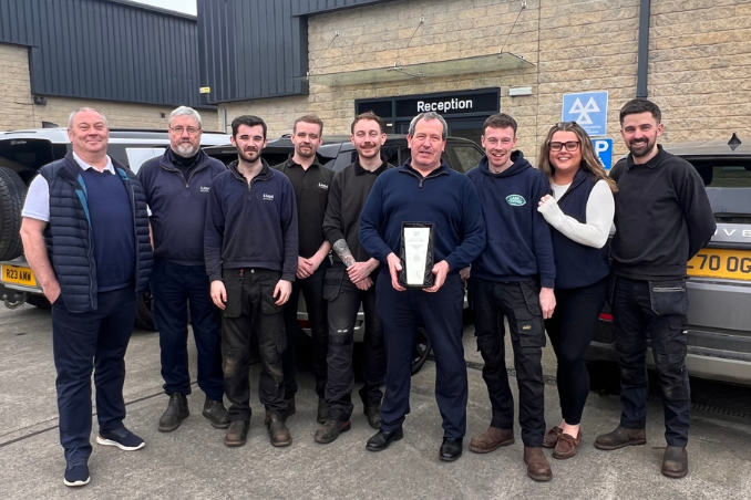 The Lloyd Land Rover Leyburn Service Centre team proudly displaying their award for Authorised Repairer of the Year