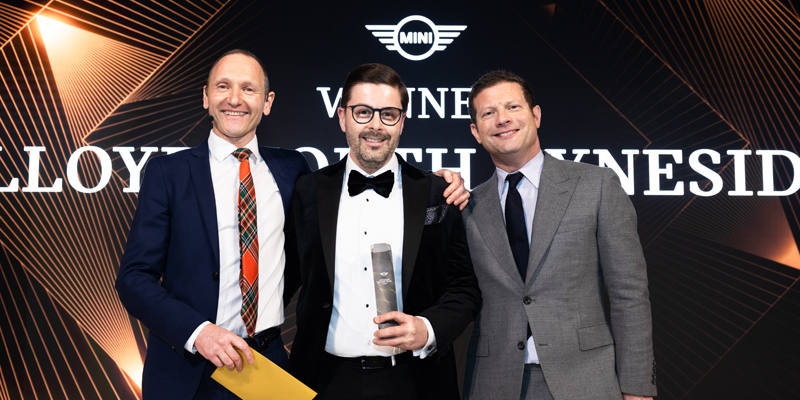 Esuan collecting the Most Improved Retailer award.