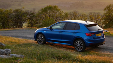 Skoda Fabia in nature landscape at sunset