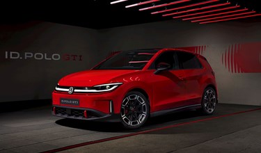 Volkswagen ID. Polo GTI concept car in Tornado Red, shown in a dramatic studio setting with red neon lighting overhead.