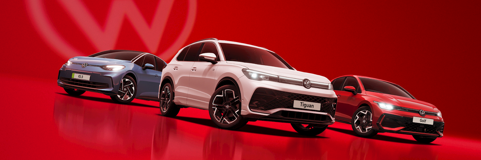 Three Volkswagen models — the ID.3, Tiguan, and Golf — displayed against a bold red background with the Volkswagen logo, alongside the text 'The Volkswagen May Event, 5th–18th May'